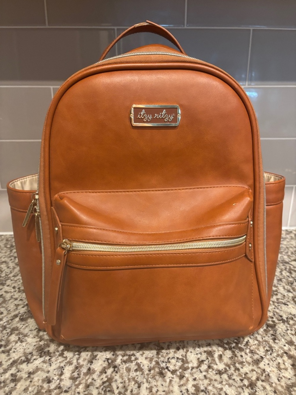 Itzy Ritzy Men's Cognac/Tan Faux Leather Backpack with Gold Hardware